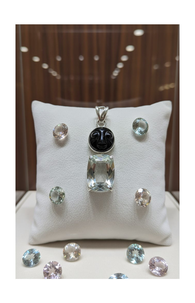 Genuine silver pendant with a mystically treated cut topaz and a carved sunstone